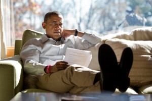 CAMP DAVID, MD - OCTOBER 21: In this handout image provided by The White House, U.S. President Barack Obama reads briefing material while meeting with advisors inside his cabin October 21, 2012 at Camp David, Maryland. The president also convened a conference call with Homeland Security Advisor John Brennan, FBI Director Robert Mueller and Chief of Staff Jack Lew to discuss the mass shooting in Wisconsin as the news unfolded. (Photo by Pete Souza/The White House via Getty Images)
